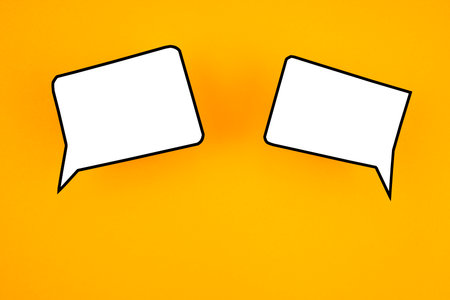 Empty white chat bubbles over yellow background. Great use for online messaging concepts.