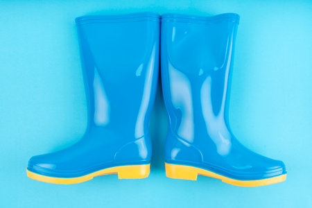 Pair of blue rubber boots on blue color background,の写真素材