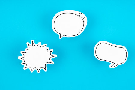 Empty white chat bubbles over blue background.の写真素材