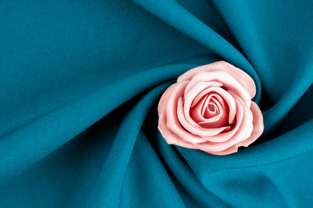 Pink color rose flower on a green satin background.の写真素材