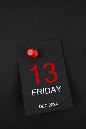 Calendar Friday the 13th December 2024 and push pin on black color background.の写真素材
