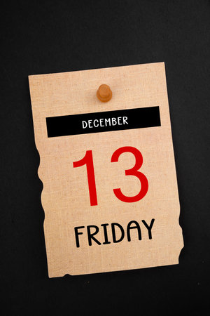Friday the 13th December calendar 2024 with wooden pin on old paper.