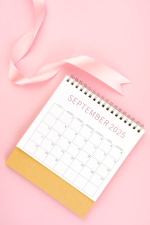 September 2025 desk calendar with pink ribbon, Flat lay.の写真素材