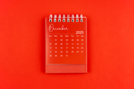 December 2025 red color desk calendar on red  background, Flat lay.の写真素材