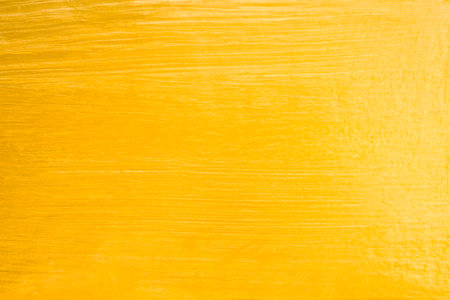 Gold color Paint on Concrete Wall Texture Background.