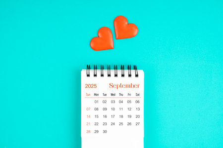 September 2025 desk calendar with red heart on blue color background.の写真素材