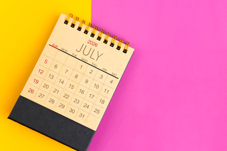 July 2026 desk calendar made from brown paper page on multicolor paper background.の写真素材