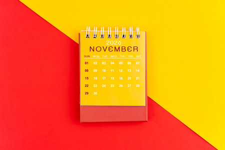 November 2026 desk calendar on red and yellow color background.の写真素材
