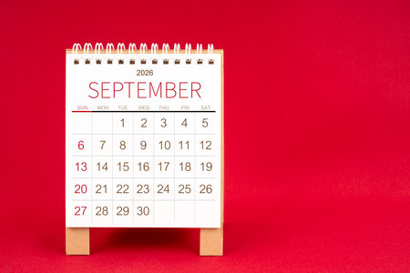 Blank desk calendar for September 2026 on red color background.の写真素材