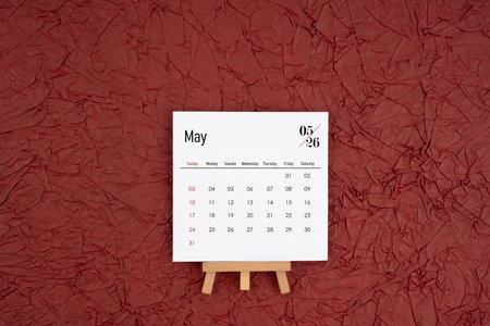 May 2026 calendar on red crumpled paper background. Directly above. Flat lay.の写真素材