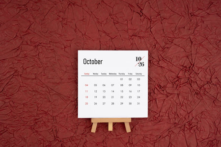 October 2026 calendar on red crumpled paper background. Directly above. Flat lay.の写真素材
