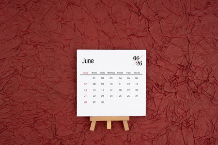 June 2026 calendar on red crumpled paper background. Directly above. Flat lay.の写真素材