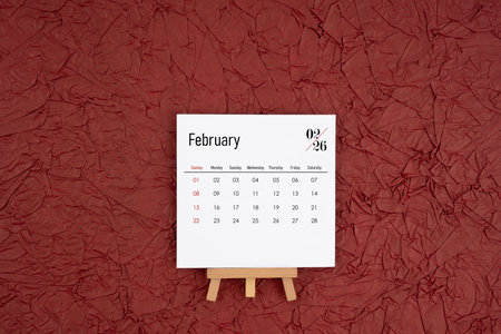 February 2026 calendar on red crumpled paper background. Directly above. Flat lay.の写真素材