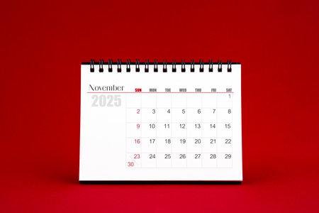 November 2025 Blank desk calendar on red color background.の写真素材