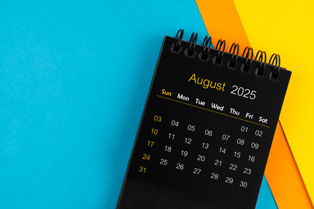 Black calendar for August 2025 on multi color background.の写真素材