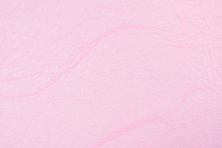 Pink color crumpled paper texture as background.の写真素材