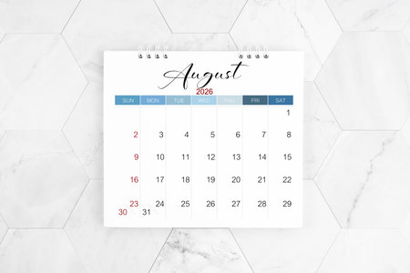 August 2026 blank desk calendar on white marble table, Flat lay.の写真素材