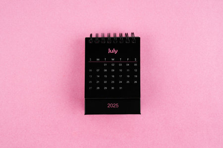 Black calendar for July 2025 year on pink color background.の写真素材