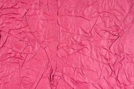 Pink color crumpled paper texture as background.の写真素材
