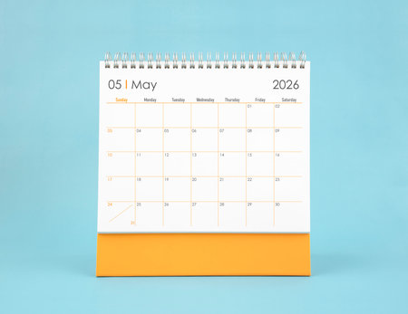 May 2026 white desk calendar on blue background. Planning and goals concepts.の写真素材