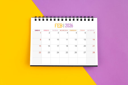 February 2026 Monthly desk calendar for 2026 year on yellow and purple background.の写真素材