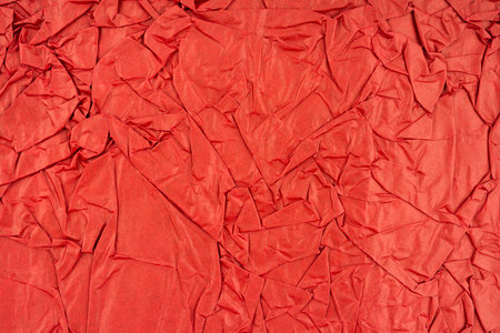 Red color crumpled paper texture as background.の写真素材