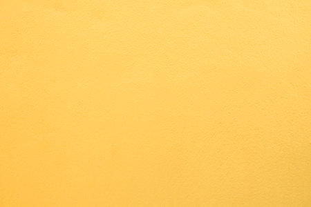 Concrete wall yellow color for background. old grunge textures with scratches and cracks.の写真素材