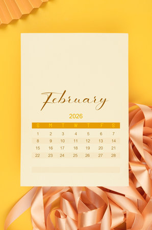 February 2026 calendar page with yellow ribbon.の写真素材