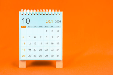 October 2026 desk calendar stand on orange textile background.の写真素材