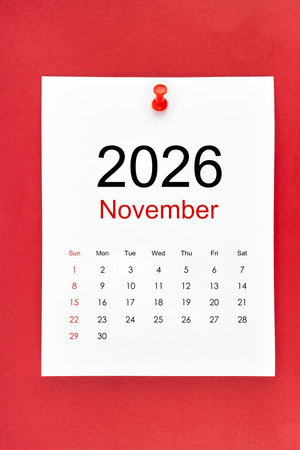 November 2026 calendar page with push pin on red background.