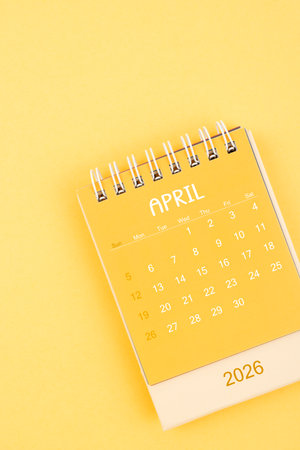 April 2026 Yellow desktop calendar on a yellow background.
