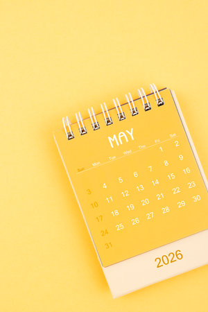 May 2026 Yellow desktop calendar on a yellow background.の写真素材