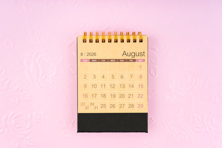 Brown paper Desk calendar for August 2026 on flower pattern embossed as background.の写真素材