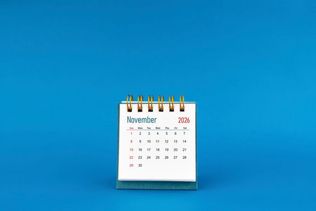 November 2026 mini desk calendar on blue background.の写真素材