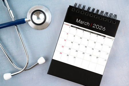 March 2026 desk calendar and stethoscope, Medical appointment schedule to check up concept.