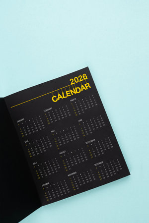 2026 black calendar page opening on blue background.