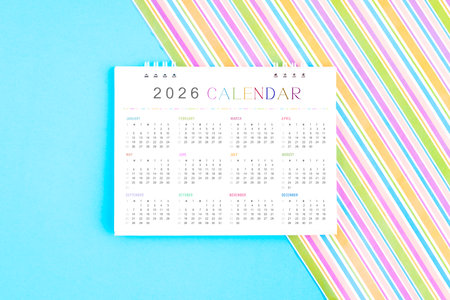 2026 desk calendar on colorful background, Flat lay.
