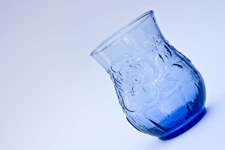 Empty blue glass on blue backgroundの写真素材
