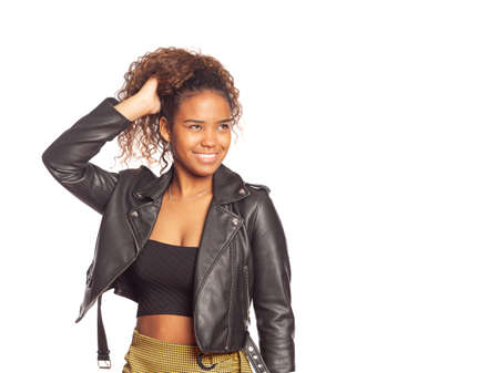 Portrait of pretty young hispanic woman with curly hair posing for the camera on isolated background.の写真素材
