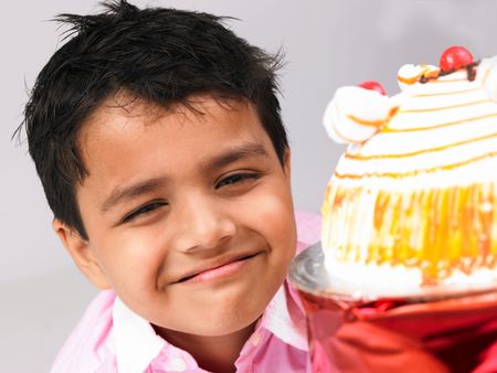 asian kid with his cakeの写真素材
