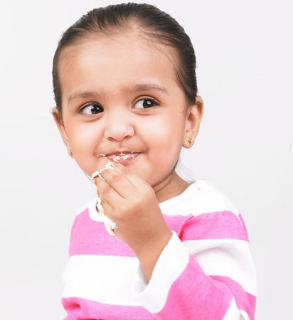 asian girl eating a piece of cakeの写真素材