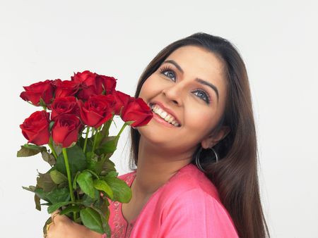asian lady with a bouquet of red rosesの写真素材