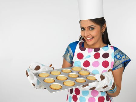 asian female baker with cookiesの写真素材