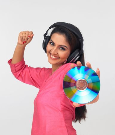 asian woman enjoying music wearing headphones