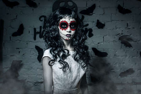 Little santa muerte girl with black curly hairの写真素材