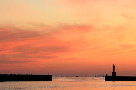 Sunset Lighthouse and Anglerの写真素材