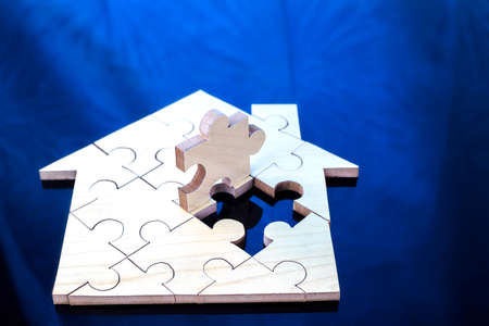 Wooden puzzle wait to fulfill home shape for build dream home or happy life concept  for property,...