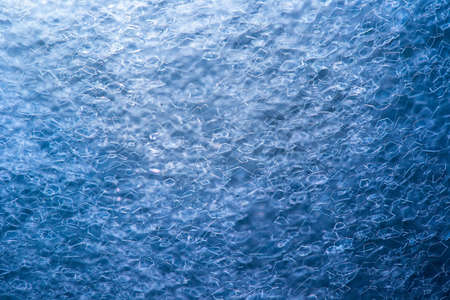 Surface of bubbles of blue background detergentの写真素材