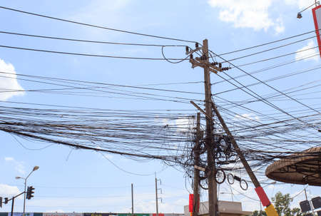 out of focus, Messy electrical cables in India. Uncovered optical fiber technology open air outdoors in Asian citiesの写真素材