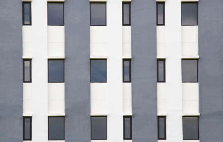 Building wall Several windows in a row on facade of urban office building front view.